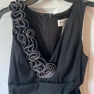 Black midi dress adorned with rose-shaped zipper.